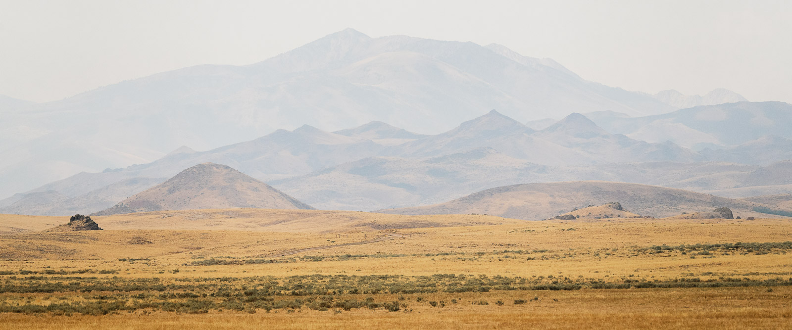 A hazy landscape as smoke from the fires begin to obscure the distant mountains